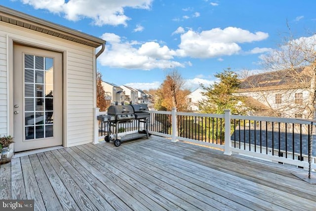 wooden terrace with a grill