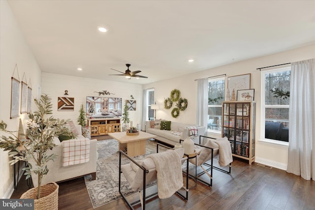 living room with dark hardwood / wood-style flooring and ceiling fan