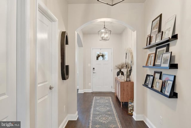 entrance foyer featuring a chandelier and dark hardwood / wood-style floors