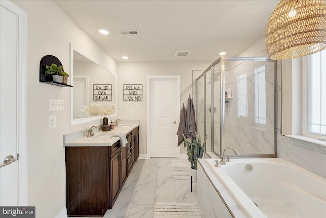 bathroom with vanity and independent shower and bath