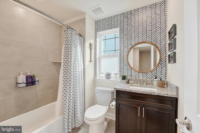 full bathroom with tile patterned floors, shower / tub combo with curtain, vanity, and toilet