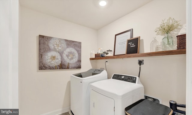 clothes washing area featuring independent washer and dryer