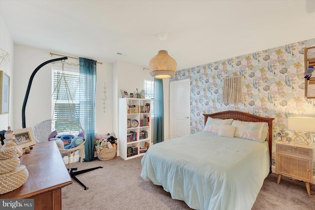 bedroom with multiple windows and carpet