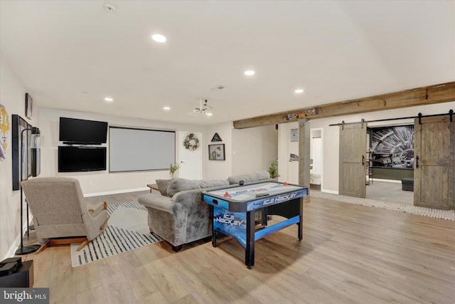 living room with light wood-type flooring and a barn door