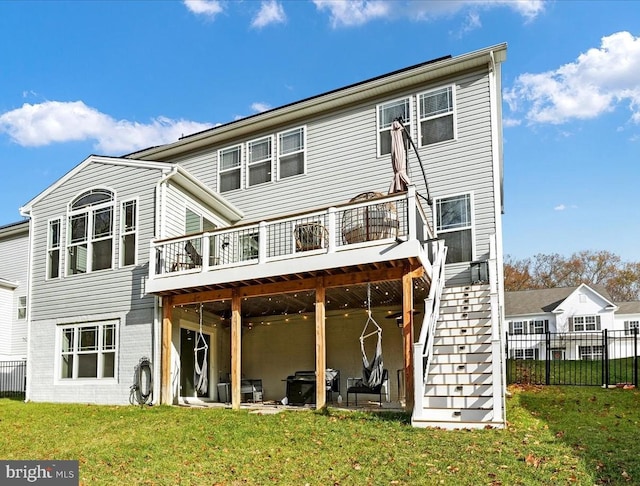 back of property with a yard and a wooden deck