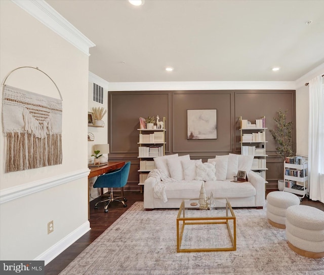 living room featuring wood-type flooring and ornamental molding