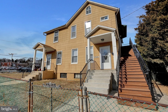 view of front of property with a fenced front yard and a gate