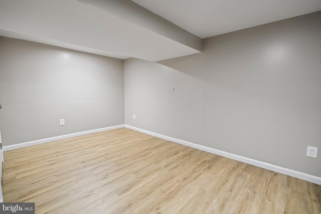 basement with light hardwood / wood-style floors