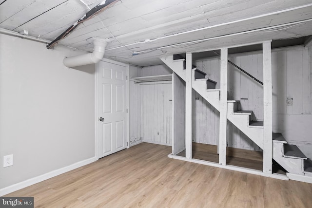 basement with light hardwood / wood-style floors