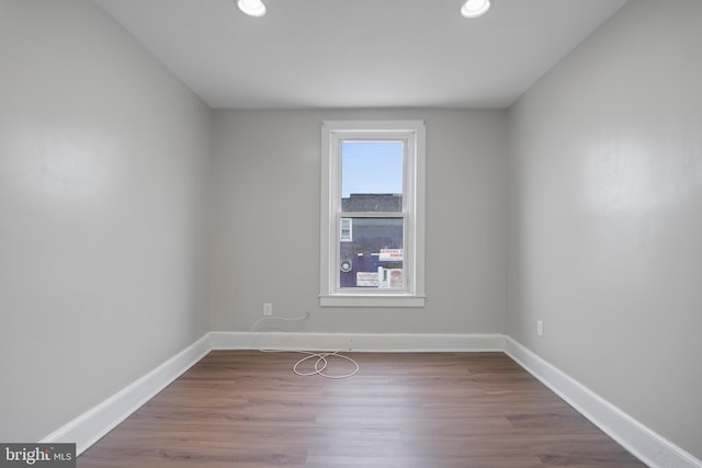 unfurnished room with hardwood / wood-style flooring