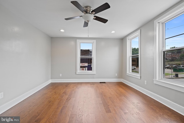 unfurnished room featuring hardwood / wood-style flooring and ceiling fan