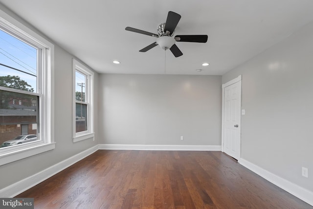 empty room with ceiling fan and dark wood-type flooring