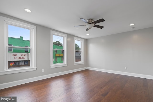 empty room featuring ceiling fan and dark wood-type flooring