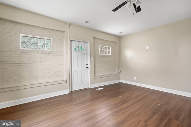 entryway with ceiling fan and dark wood-type flooring