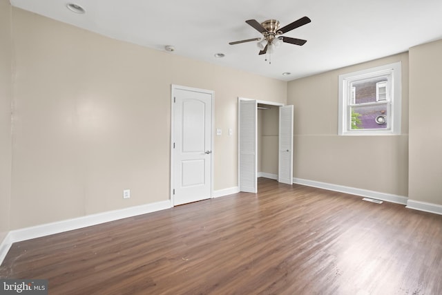 unfurnished bedroom featuring dark hardwood / wood-style flooring and ceiling fan