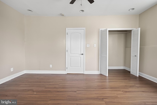 unfurnished bedroom with ceiling fan and dark hardwood / wood-style floors