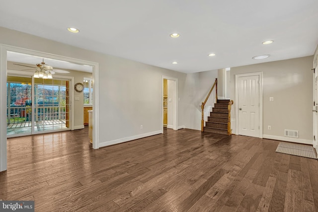 unfurnished living room featuring ceiling fan and dark wood-type flooring