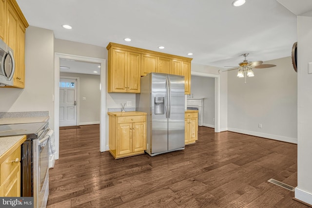 kitchen with ceiling fan, light brown cabinets, dark hardwood / wood-style flooring, and appliances with stainless steel finishes