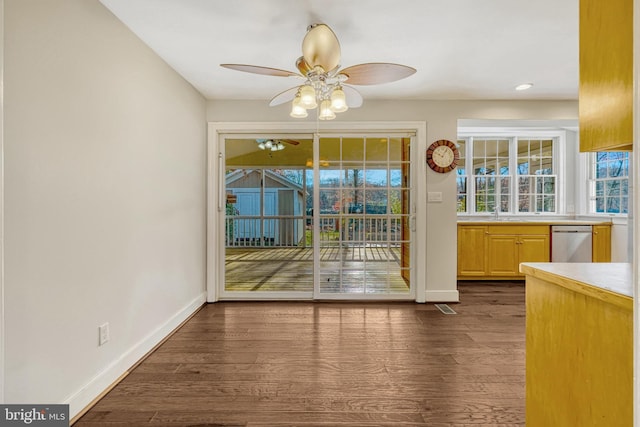 doorway with ceiling fan, sink, and dark hardwood / wood-style floors