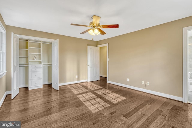 unfurnished bedroom featuring a closet, ceiling fan, and dark hardwood / wood-style flooring