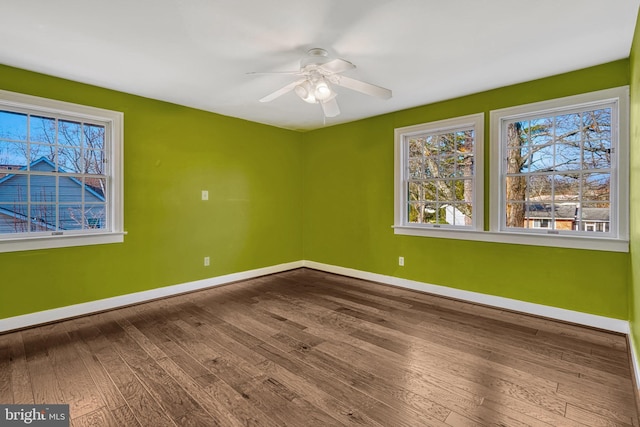 spare room featuring ceiling fan and hardwood / wood-style flooring