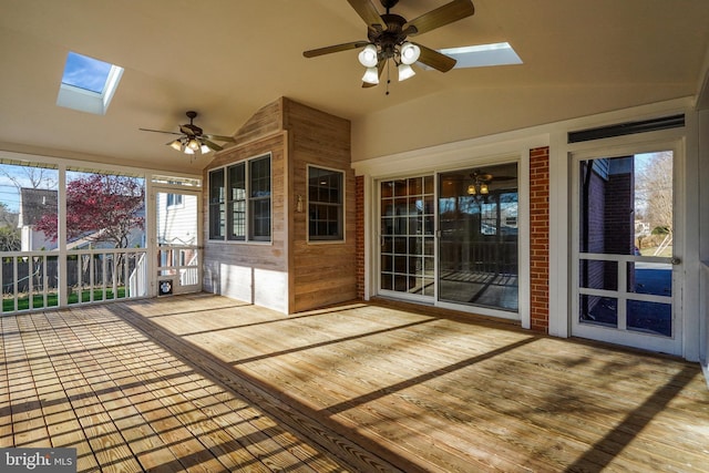 unfurnished sunroom with ceiling fan and lofted ceiling