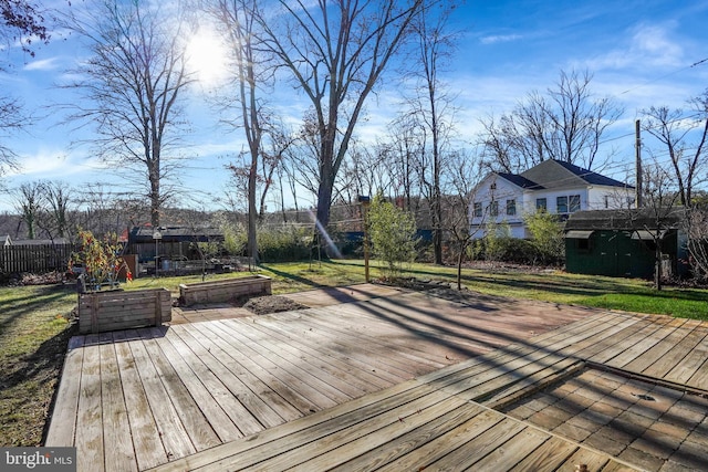 wooden terrace with a lawn