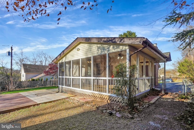 view of side of home with a sunroom and a deck