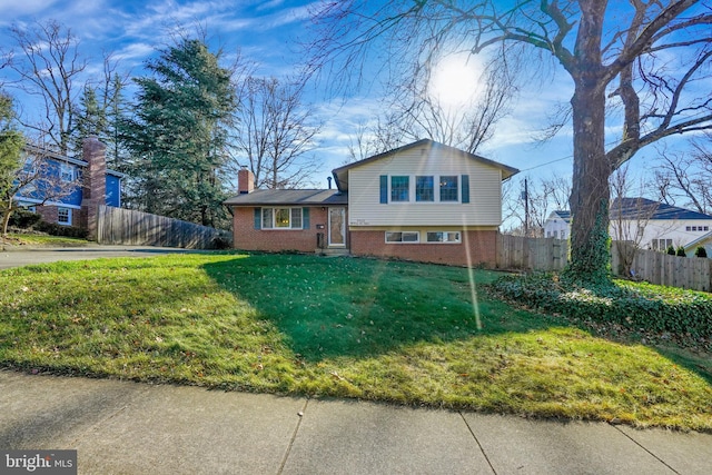 tri-level home with a front lawn