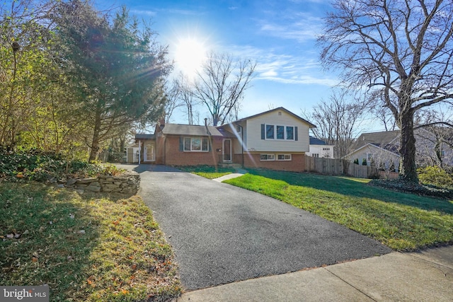 tri-level home with a front yard