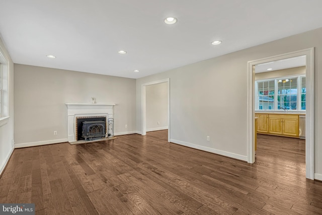 unfurnished living room with dark hardwood / wood-style flooring and sink