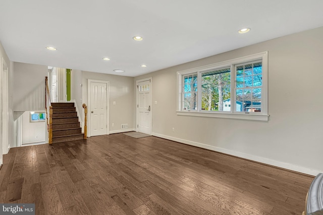 unfurnished living room with dark hardwood / wood-style flooring