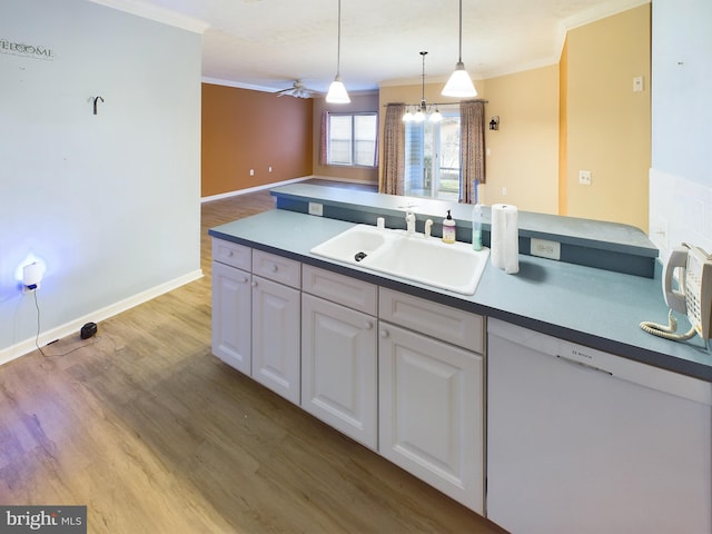 kitchen featuring white cabinets, ceiling fan with notable chandelier, sink, pendant lighting, and dishwasher