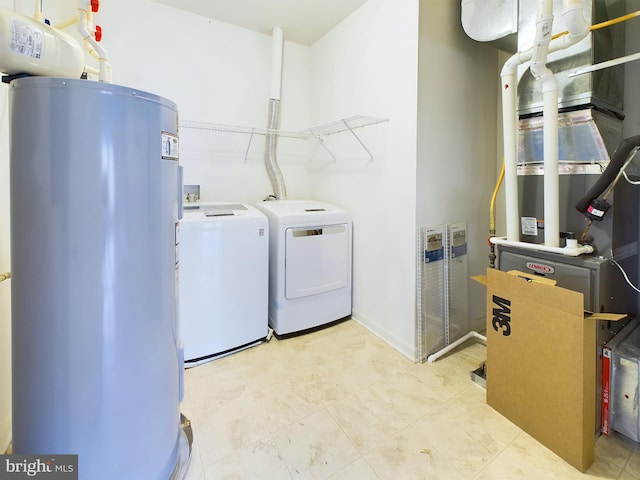 laundry area with washing machine and dryer and water heater