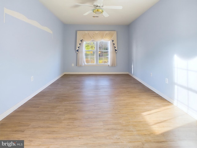 empty room featuring ceiling fan and light hardwood / wood-style floors