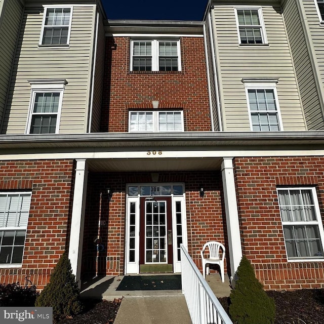 view of exterior entry featuring a porch