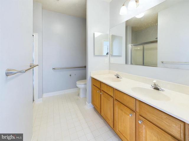 bathroom with toilet, vanity, tile patterned floors, and an enclosed shower