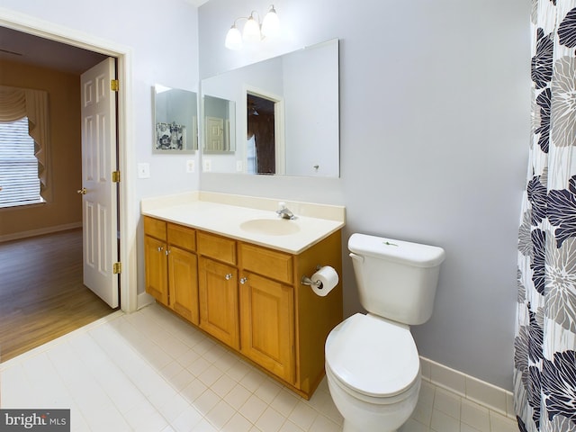 bathroom featuring tile patterned flooring, vanity, and toilet