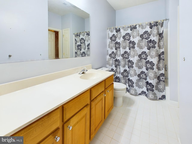 bathroom with tile patterned floors, curtained shower, vanity, and toilet