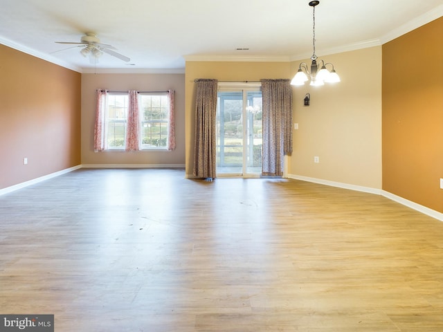 spare room with light wood-type flooring, ceiling fan with notable chandelier, and crown molding