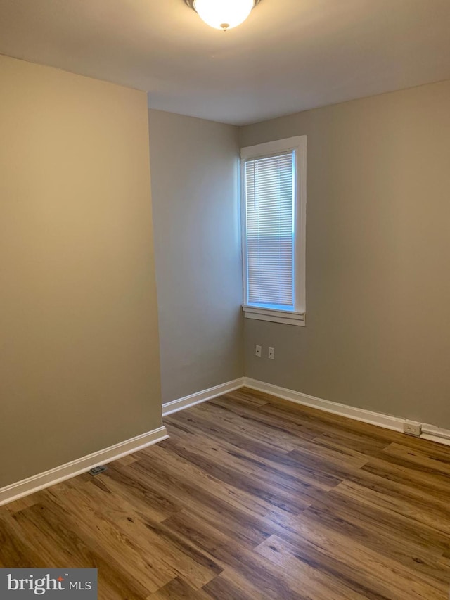 empty room with dark hardwood / wood-style floors