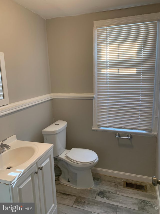 bathroom featuring vanity and toilet