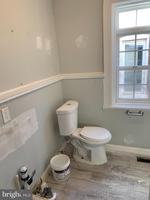 bathroom with wood-type flooring and toilet