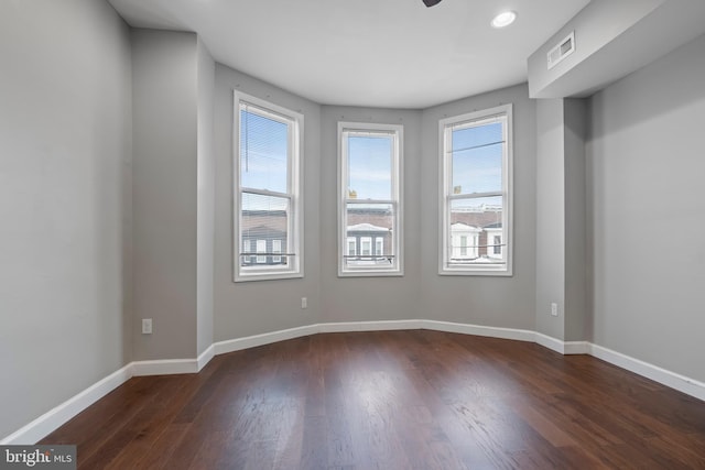 spare room with dark hardwood / wood-style floors