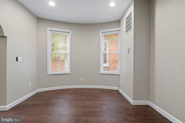 spare room with dark wood-type flooring