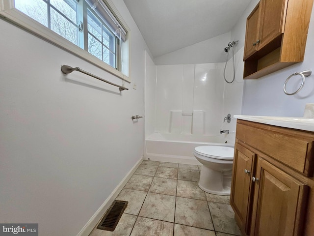 full bathroom featuring tile patterned floors, vanity, vaulted ceiling, shower / washtub combination, and toilet