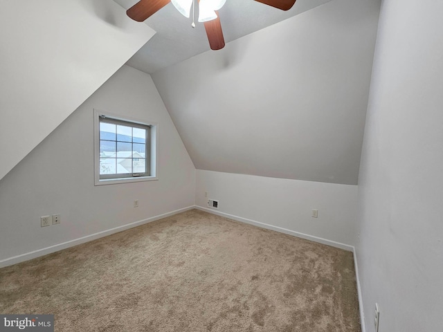 bonus room featuring light carpet, ceiling fan, and vaulted ceiling