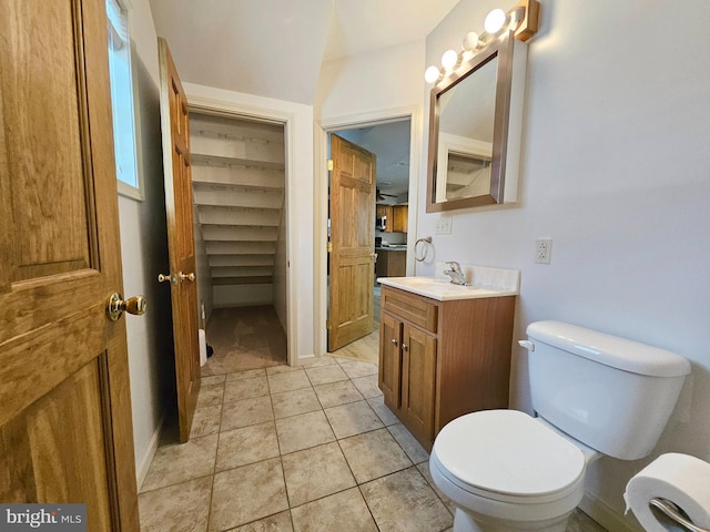 bathroom featuring tile patterned flooring, vanity, and toilet