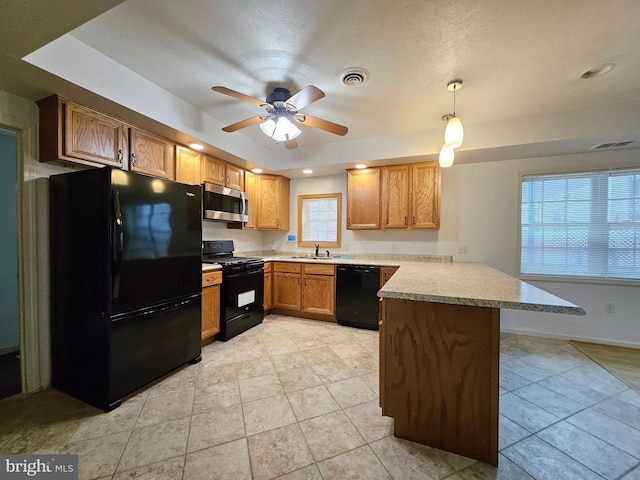 kitchen with pendant lighting, a breakfast bar, black appliances, ceiling fan, and kitchen peninsula