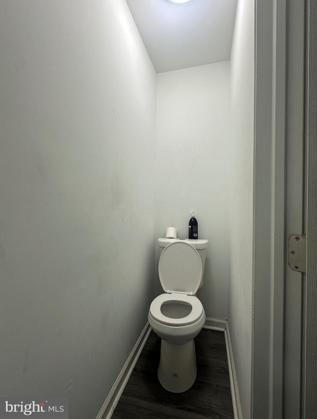 bathroom featuring hardwood / wood-style flooring and toilet